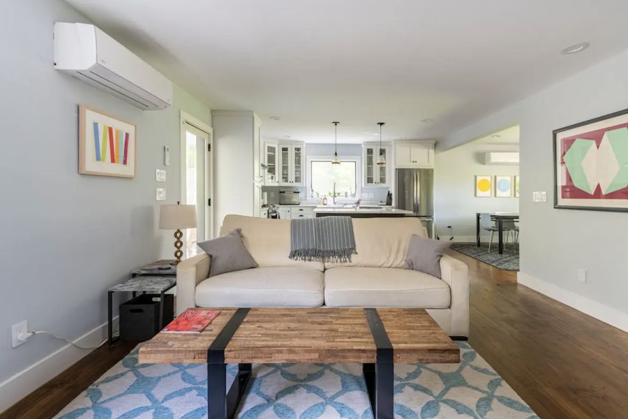 Living room with sofa, wood coffee table and patterned rug