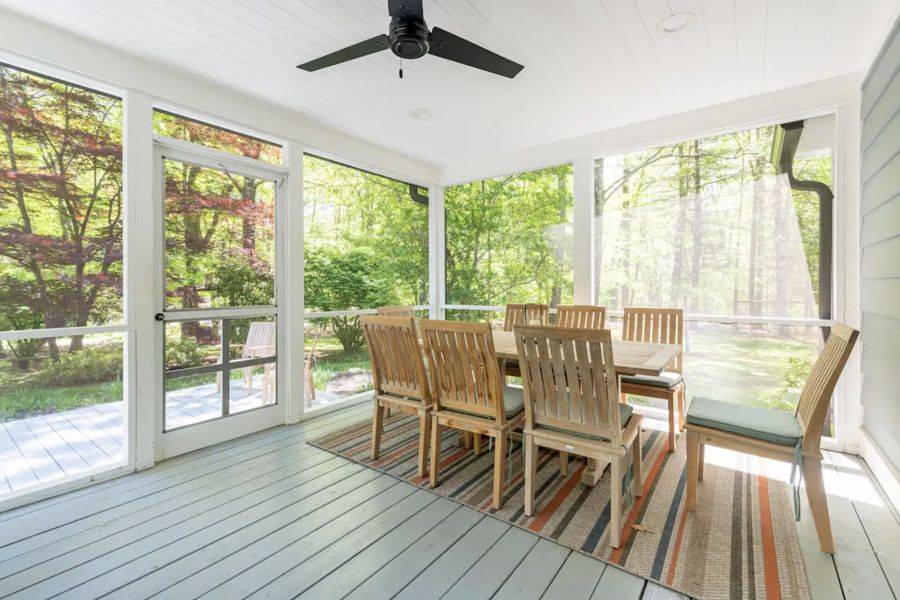 Teak dining table on the screened porch