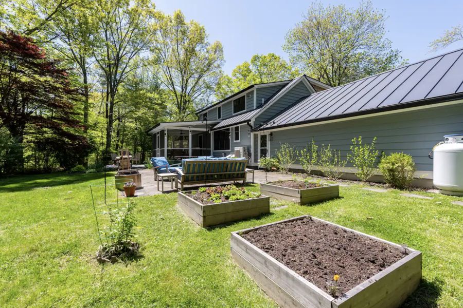 Back of the house with raised garden beds
